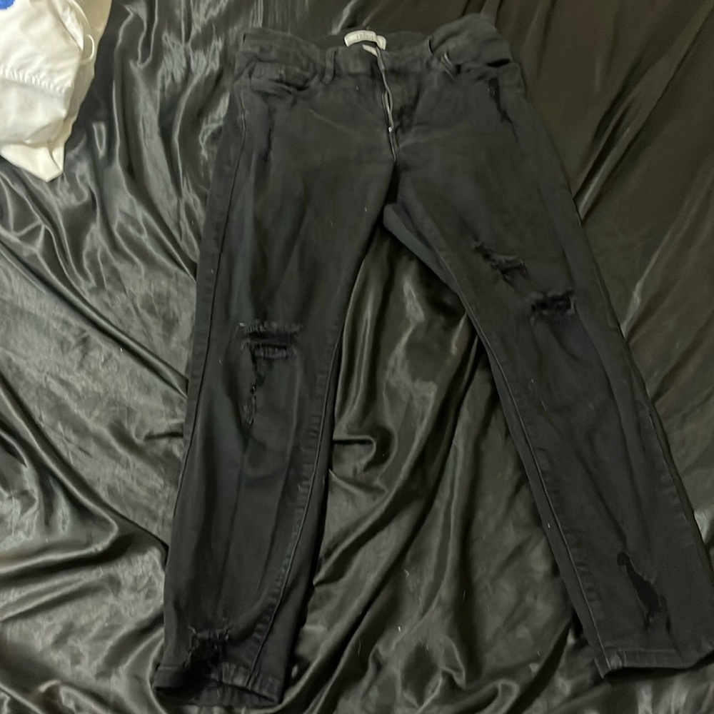 Black ripped skinny jeans.
